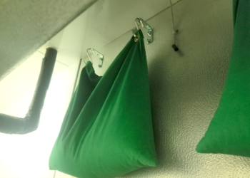 A green bag hanging on the wall